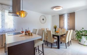 a kitchen and dining room with a table and chairs at Beautiful Home In Pula in Pula