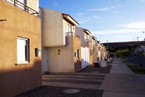an empty sidewalk next to a row of buildings at Casas Puerto de Vega in Vallenar