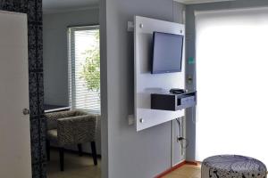 a room with a tv and a chair and a window at Casas Puerto de Vega in Vallenar