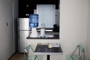 a kitchen with a blender and a refrigerator at Casas Puerto de Vega in Vallenar