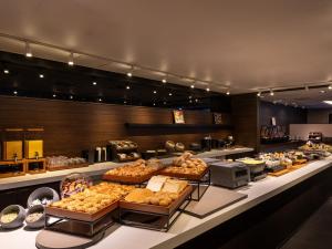 a bakery with many different types of pastries on display at Loisir Hotel Classic Garden Kyoto Sanjo in Kyoto