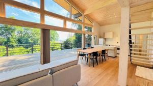 a large living room with a table and chairs at Terrace Villa Foresta Asama in Miyota