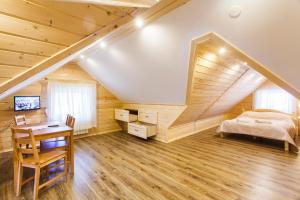 a bedroom with a bed and a desk in a room at Chata u Bronka in Białka Tatrzanska