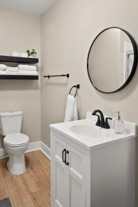 a bathroom with a white sink and a mirror at Parkside Escape in New Albany +56 photos