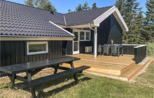 a wooden deck with a bench in front of a house at Holiday Home Kuskevej Jerup X in Jerup