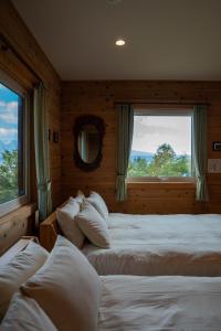 a bedroom with two beds and a window at Best View in Nakafurano