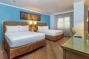Postel nebo postele na pokoji v ubytování Grand Hotel Guayaquil, Ascend Hotel Collection