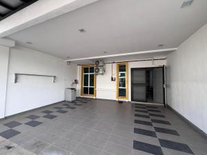 an empty room with a checkered floor at Meera Homestay in Malacca +5 photos