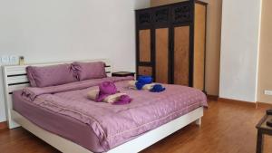 two dogs laying on a bed with purple sheets at Mosaic condominium AD63M in Ban Tha Fat +30 photos