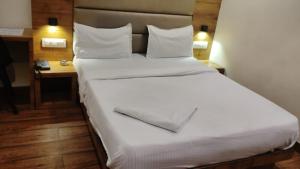 a large white bed in a hotel room at Hotel Hoxton in Mumbai