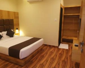 a bedroom with a bed and a walk in shower at Hotel Hoxton in Mumbai
