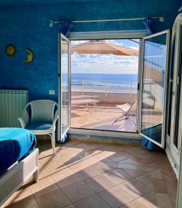 a bedroom with a bed and a view of the ocean at Casa MaTu in Nettuno