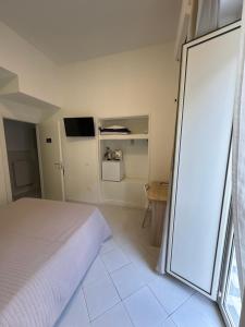a bedroom with a bed and a sliding glass door at Grillo in Salerno