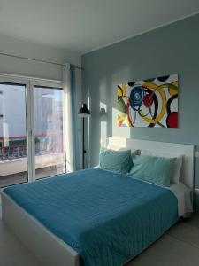 a bedroom with a blue bed and a window at B&B La Finestra sul Mare in Milazzo