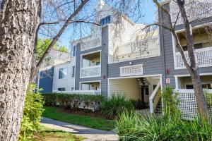 an apartment building with white balconies and trees at Blueground Santa Clara pool nr tech hub shops SFO-1672 in Santa Clara