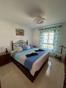 Ένα ή περισσότερα κρεβάτια σε δωμάτιο στο La Palmita House Flat