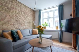 a living room with a couch and a tv at Cherryy in Copenhagen