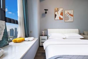 Postel nebo postele na pokoji v ubytování Suyi Hotel Apartment