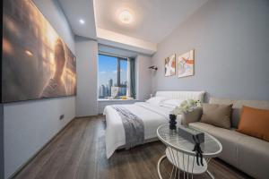 Postel nebo postele na pokoji v ubytování Suyi Hotel Apartment