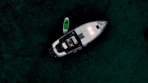a small boat in the water at night at Sleeping on a boat in the Island's bay in Porto San Paolo