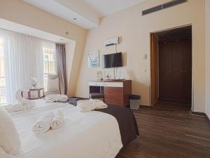 a hotel room with a bed and a desk at Holiday Beach Budapest Wellness Hotel with Sauna Park in Budapest