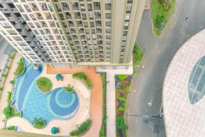 an overhead view of a building with a swimming pool at Good Deal 2BR Apartment at Transpark Cibubur near Shopping Center By Travelio in Depok