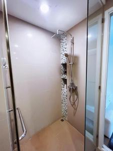 a shower with a glass door in a bathroom at Lucky Room in Ban Bang Saen (1)