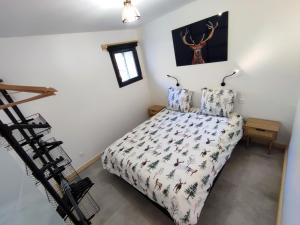 a bedroom with a bed with a deer picture on the wall at Le Bois Cosy appartement 4 étoiles 6 personnes, ACCES SKI ALPE D'HUEZ GRAND DOMAINE A 3 K M in Allemont +76 photos