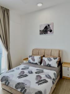 a bedroom with a bed with a zebra picture on the wall at BaySuites Likas by Alawa Homes in Kota Kinabalu