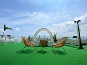 two chairs and a table on top of a roof at El Coco Boutique Hotel in Ibabang Talim