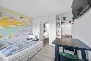 a bedroom with a bed and a table in it at Studio Apartment Pulse Zagreb Knezija in Zagreb