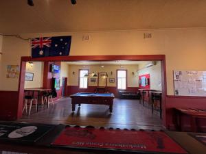 a room with a pool table in the middle of it at Royal Mail Hotel - Meekatharra in Meekatharra