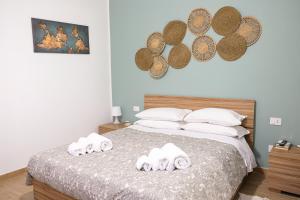 a bedroom with a bed with towels on it at Home Sweet Home da Viky in Bari