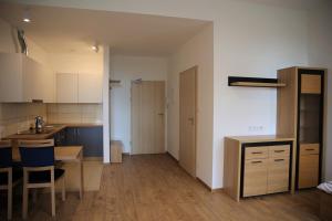 a kitchen with a table and a dining room at Dom Studenta Pod Jelonkiem in Jelenia Góra