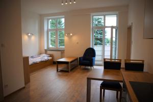 a room with a bed and a table and chairs at Dom Studenta Pod Jelonkiem in Jelenia Góra