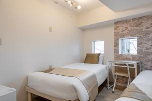 Postel nebo postele na pokoji v ubytování 東新宿 1110