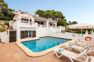 a villa with a swimming pool and a house at Villa Catalina in Alaior