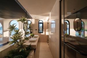 a bathroom with two sinks and two palm trees at Sanjian Twilight Diary Seaview Hotel in Dali +151 photos