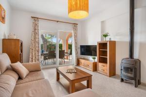 a living room with a couch and a stove at Villa Cristina in Cala Blanca