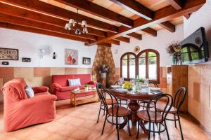 a living room with a table and chairs at Villa Can Biel by Escape Home in Cala Morell