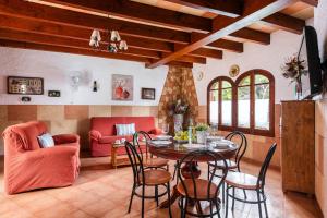 a living room with a table and chairs at Villa Can Biel by Escape Home in Cala Morell