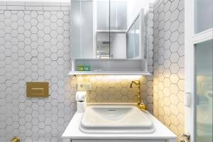 a white bathroom with a sink and a mirror at Liberty Residence in Istanbul