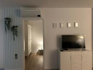 a living room with a flat screen tv on a white wall at MM Apartments Zore in Zagreb