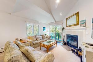 a living room with a couch and a fireplace at The Woods - Village-40 in Killington