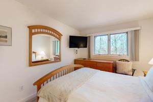 a bedroom with a bed and a mirror and a desk at The Woods - Village-40 in Killington +18 photos