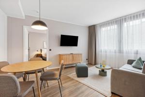 a living room with a table and a couch at Limehome Zwickau Magazinstr in Zwickau
