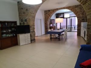 a dining room with a blue table and a tv at A 20 passi dal mare in Giardini Naxos +20 photos