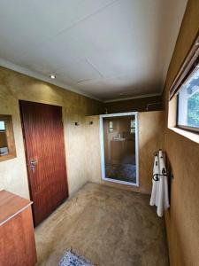 an empty room with a door and a window at LapaManzi 8 in Lindequesdrif