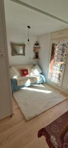 a small bedroom with a bed and a window at Appartement vue montagne proximité ski et parcours TMB in Les Contamines-Montjoie