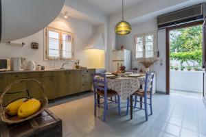 a kitchen with a table with a bunch of bananas on it at Eleni's town apartment in Skopelos Town